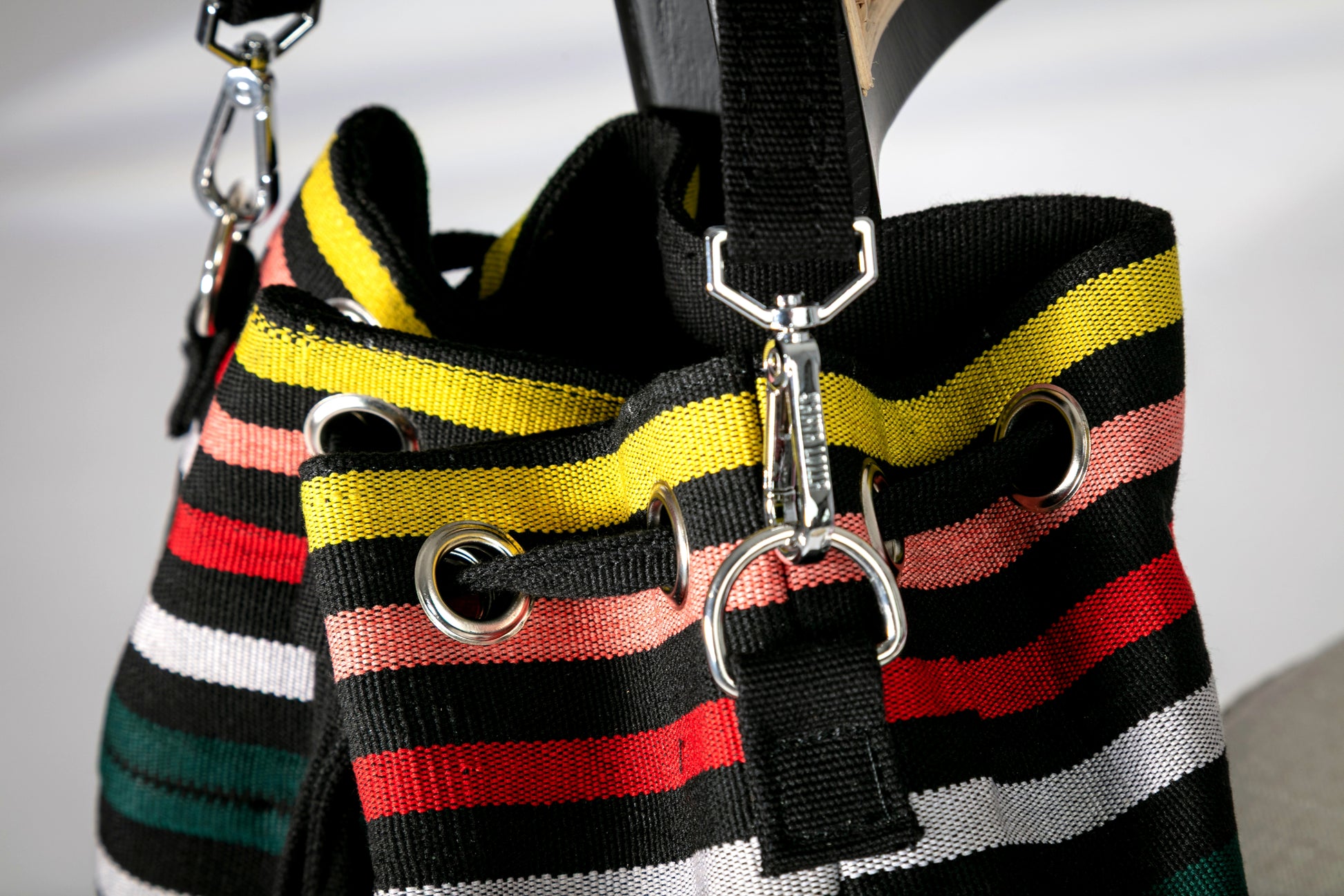 Close-up of multicolor striped bucket bag with a drawstring closure 