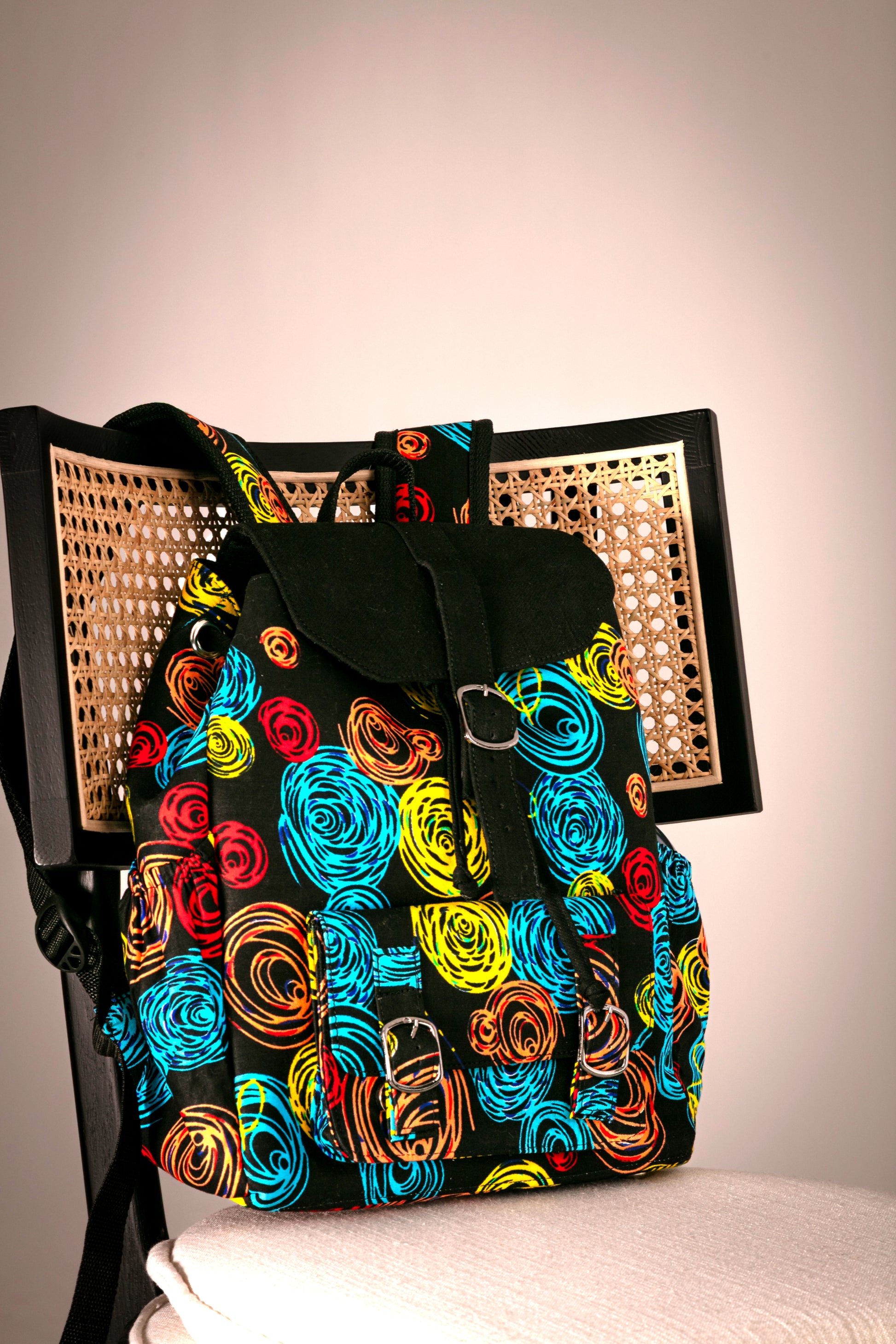 Backpack with colorful circular pattern on a chair 