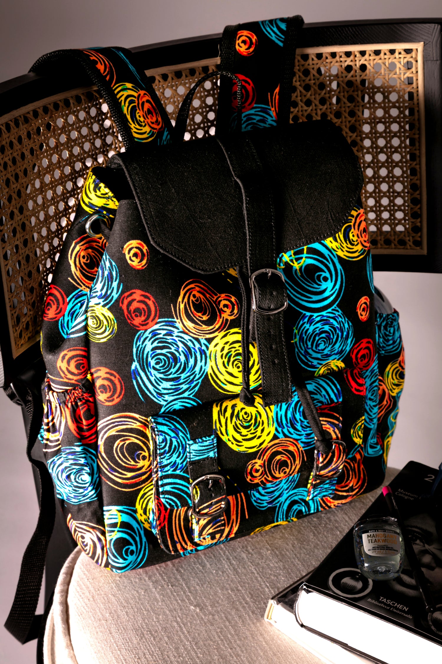 Front view of backpack with colorful circular pattern on a chair 