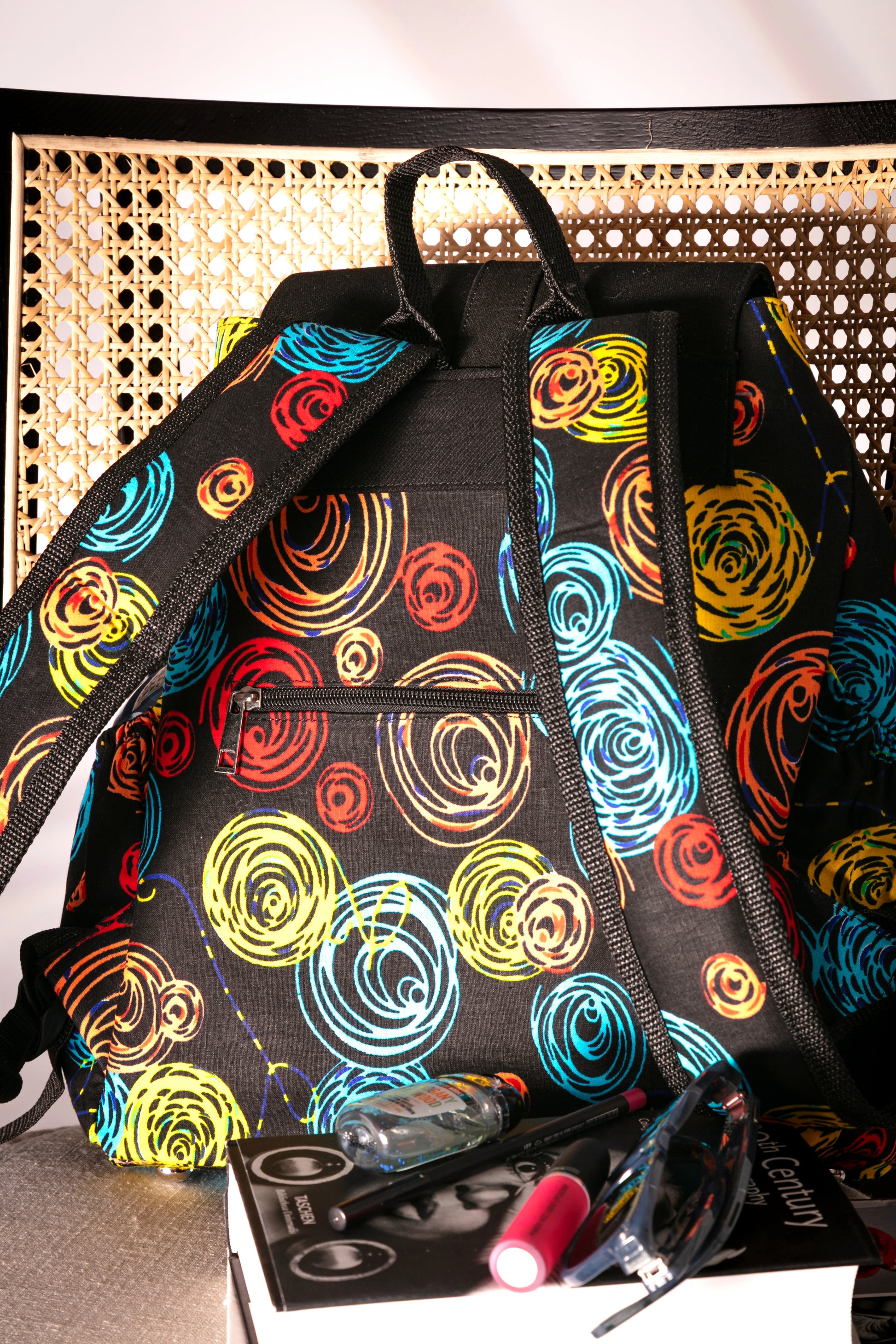 Back view of Backpack with colorful circular pattern on a chair