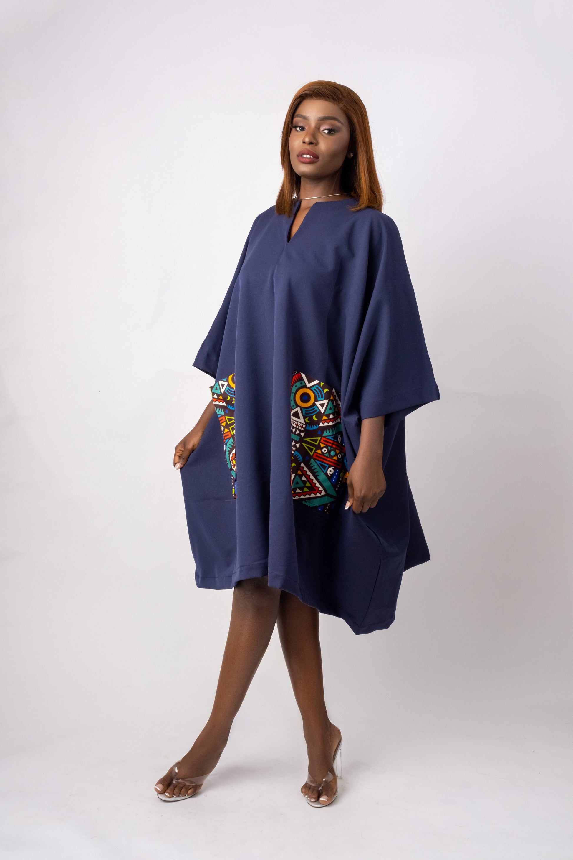 Navy blue tunic with two front pockets embellished with geometric ankara/african print fabric.