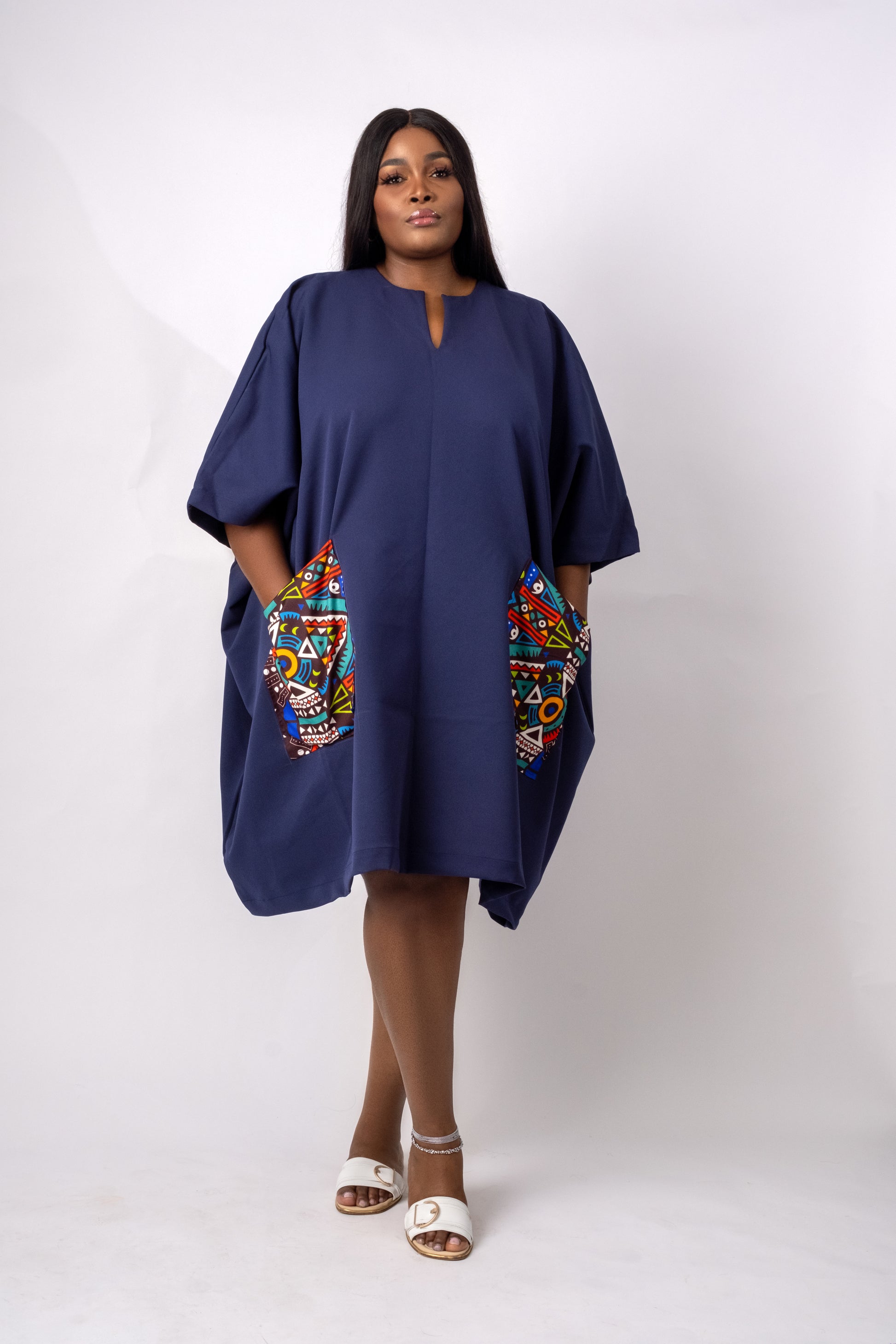 Navy blue tunic with two front pockets embellished with geometric ankara/african print fabric.