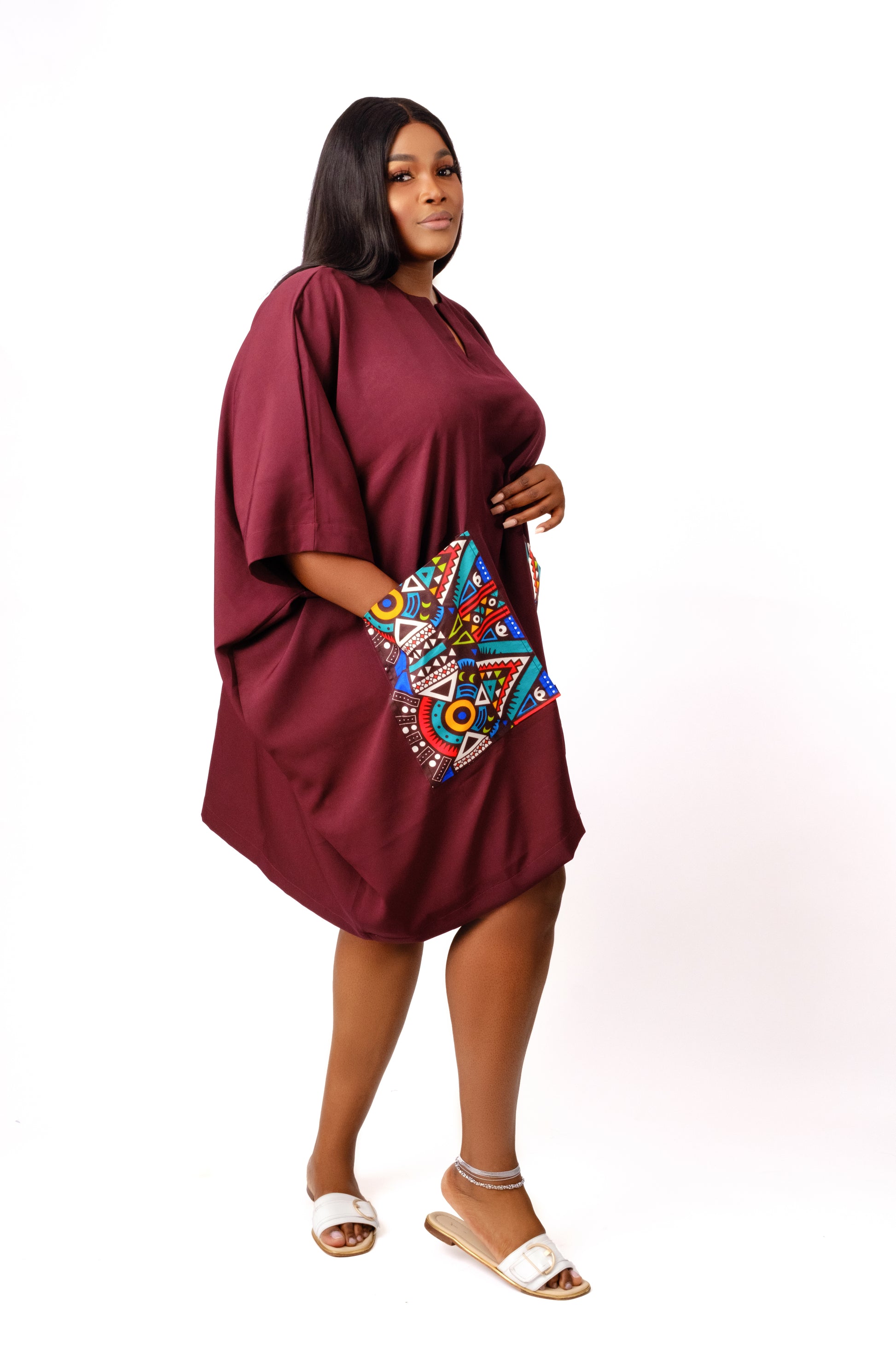 Wine tunic with two front pockets embellished with geometric ankara/african print fabric.