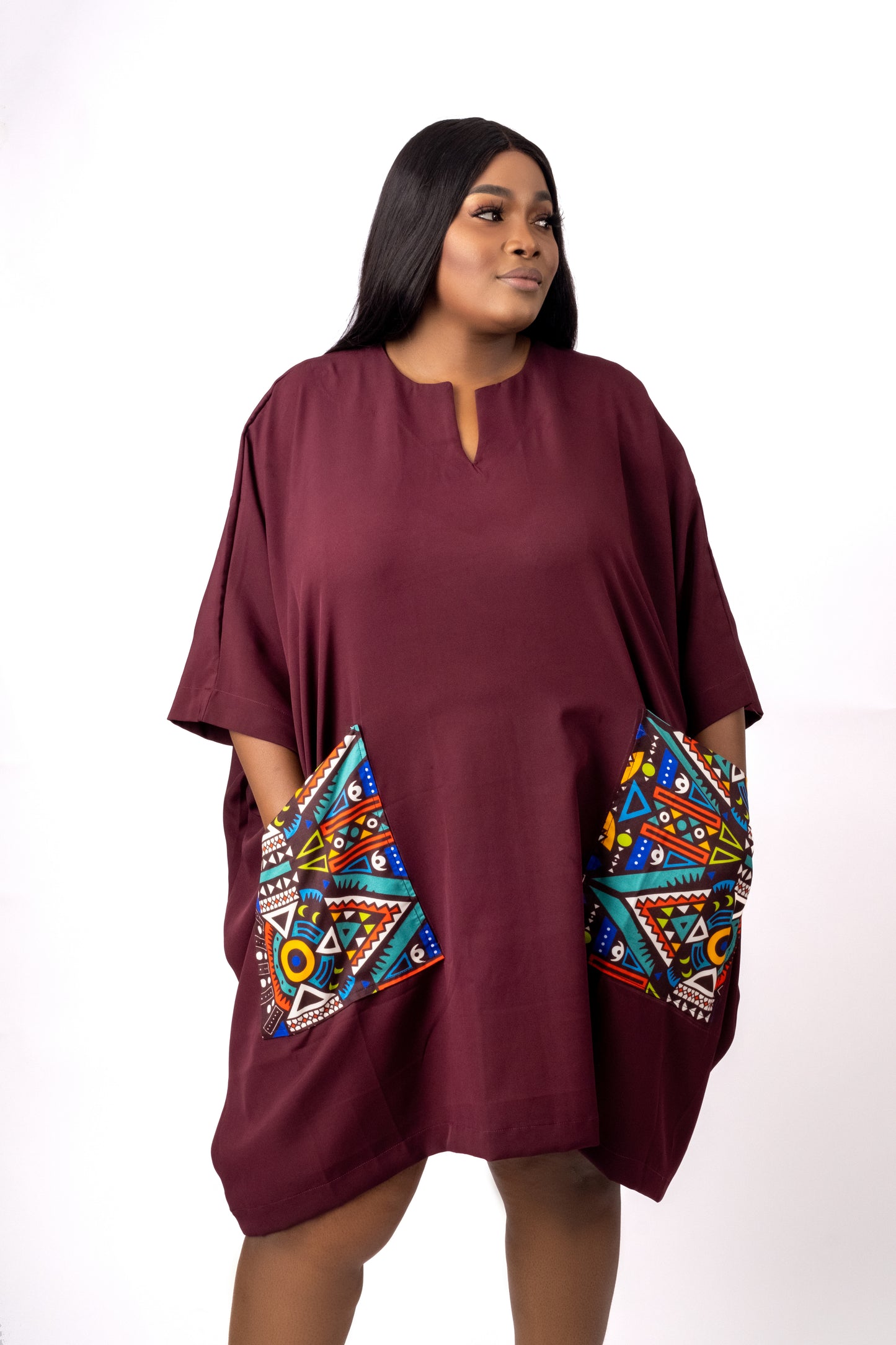 Wine tunic with two front pockets embellished with geometric ankara/african print fabric.