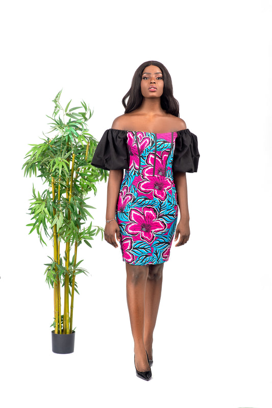 She'll turn heads in this African print corset Dress! With an off-the-shoulder neckline, black puffy sleeves, and fitted silhouette, this piece is the perfect party dress. With a back zipper closure, this dress can be worn with or without a bra. Pair with black heels and a clutch for a chic look.   Dress is named after the Fulani ethnic group (from Nigeria) dance style; Koroso.   Ankara wax cotton