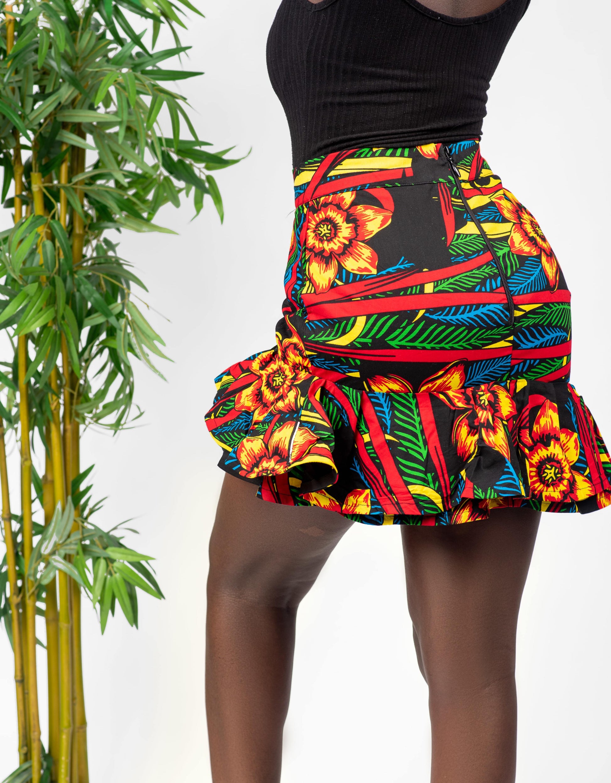 This African print skirt is Asymmetrical and features ruffles at the bottom. The asymmetrical hemline adds an element of interest, and the ruffles are fun and flirty. This skirt is perfect for women who want to stand out and be unique. Skirt is named after the Igbo ethnic group (from Nigeria) dance style; Atilogwu. Ankara skirt