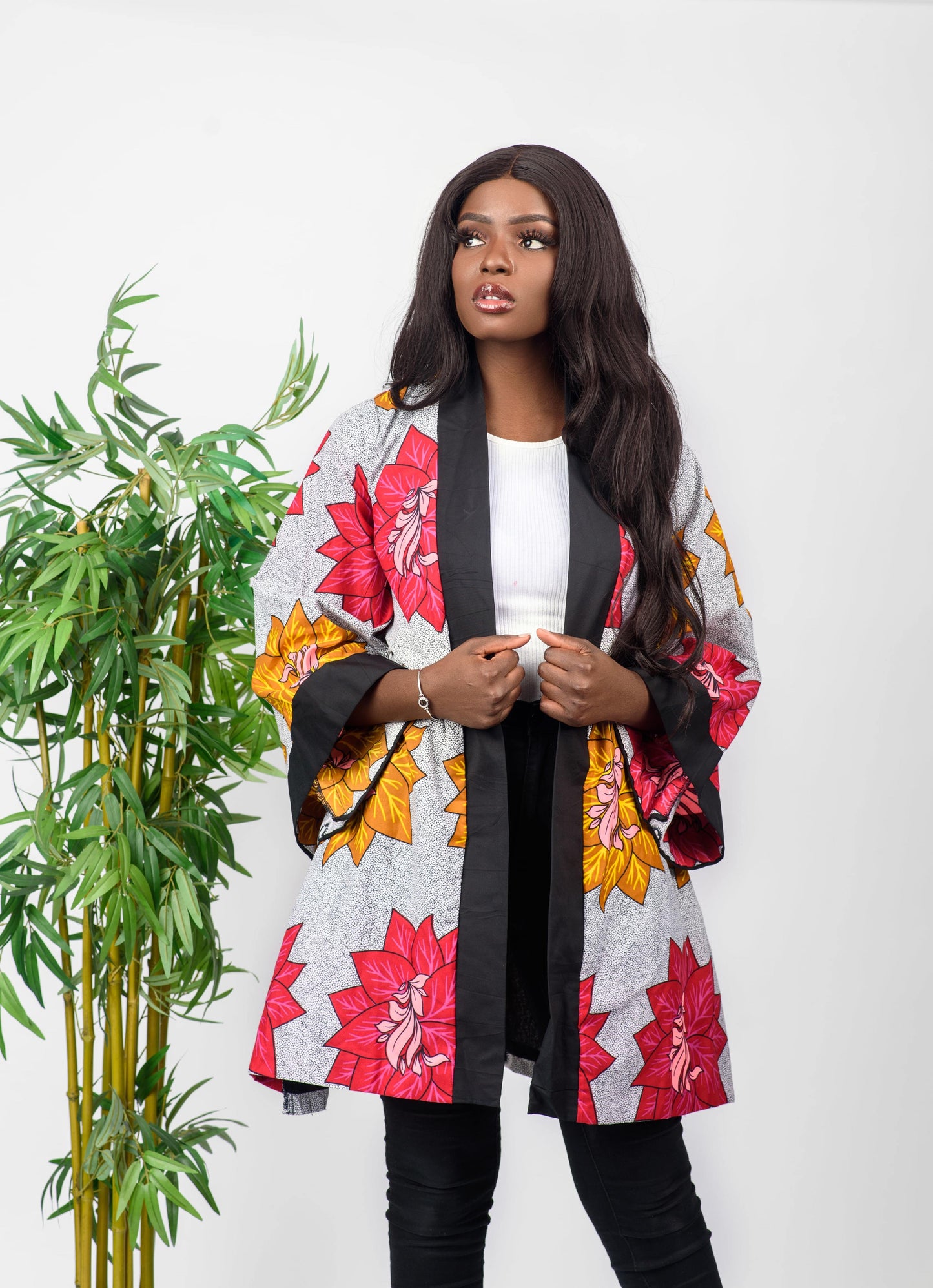 This African print kimono is a beautiful piece that can be worn as a jacket or a dress. The bold print of the kimono will get you noticed and the vibrant colors will make you stand out.  It can be paired with any outfit and can also be worn all year round.   Kimono is named after the Fulani ethnic group (from Nigeria) dance style; Sharo   Ankara wax cotton